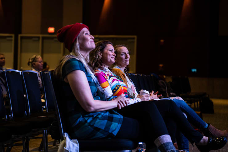 Three attendees watching a presentation at Endurance Exchange.